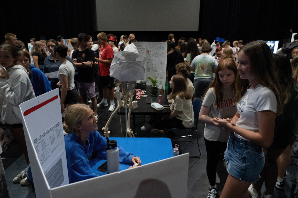 Freshmen visit Ava Ott at Harvard Model Congress table.