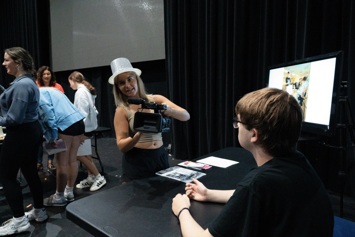 Bryce Martin of Grizzly Cub Network showcasing camcorder to freshman.