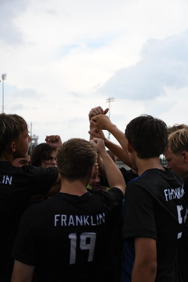 Varsity starters huddle before the game.