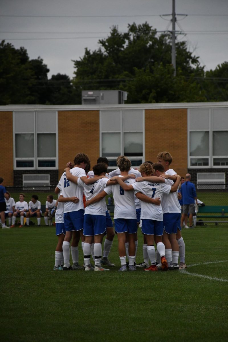 Varsity starters huddle before the start of the game.