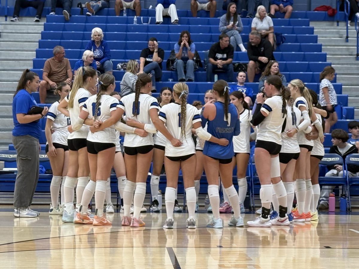 Volleyball team huddled