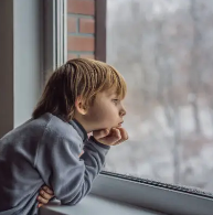 Sad kid looking at snow